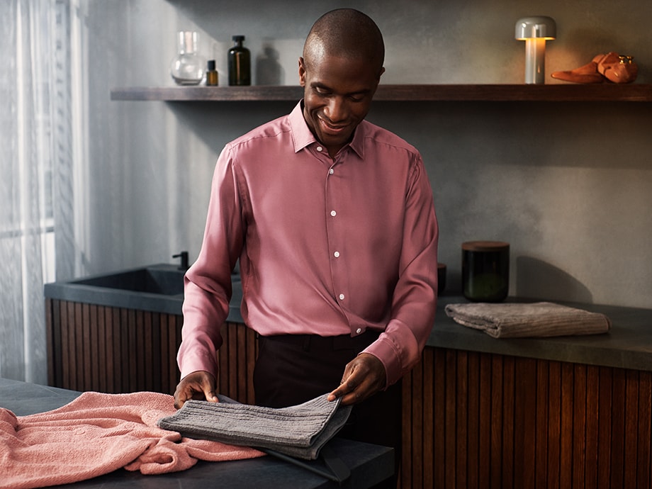 man folding towel